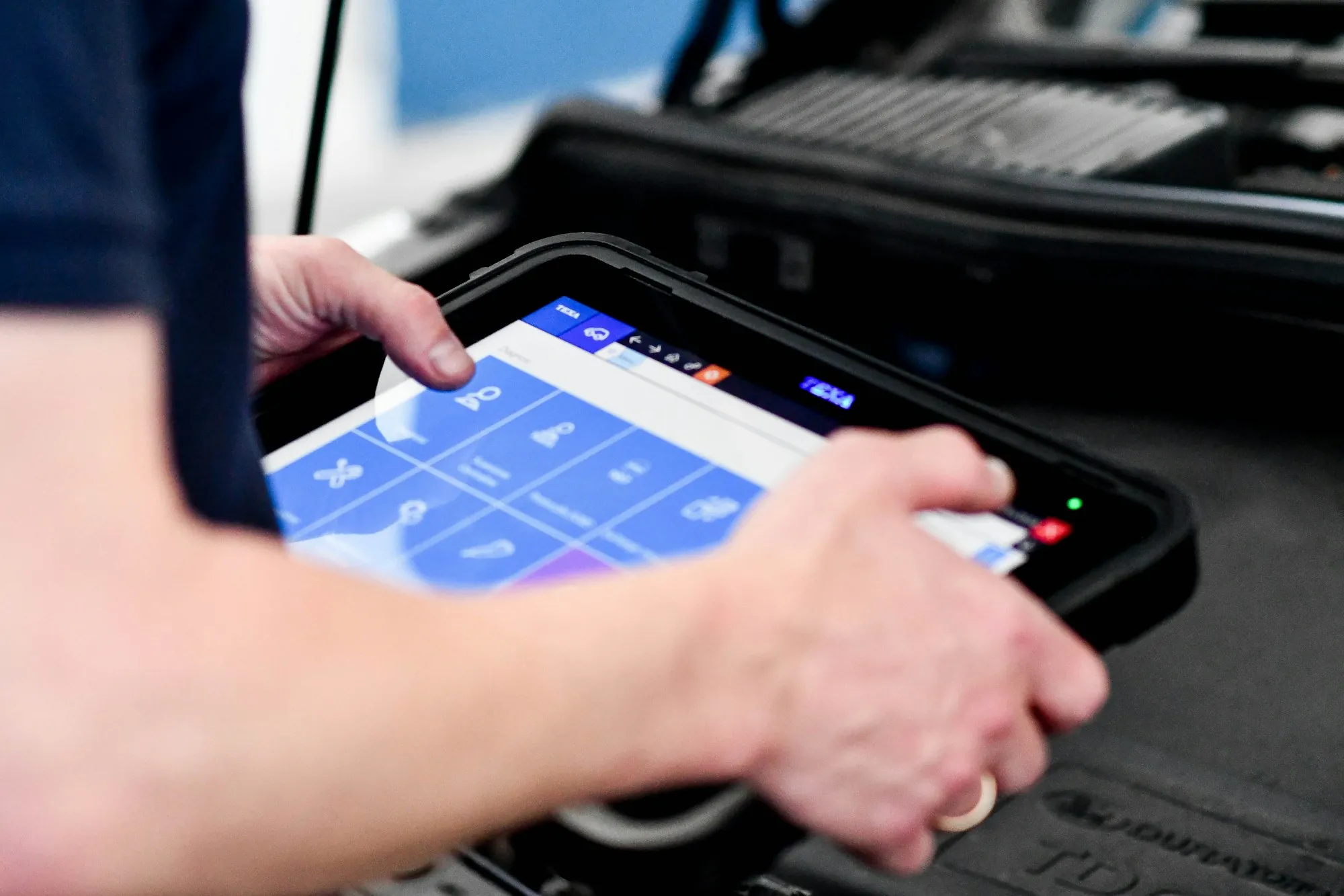 Technician holding a diagnostic tablet